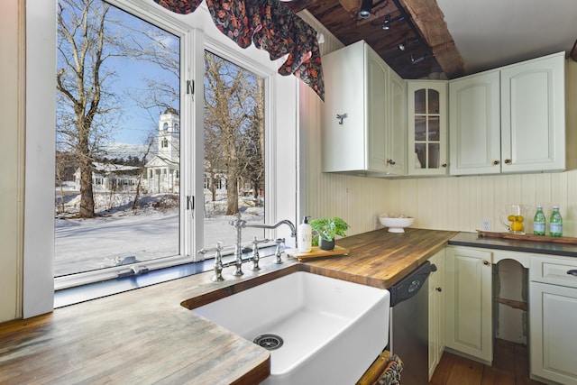 kitchen with sink, white cabinetry, wooden counters, stainless steel dishwasher, and dark hardwood / wood-style floors