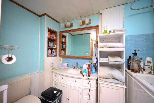 full bathroom with toilet, tasteful backsplash, vanity, and crown molding