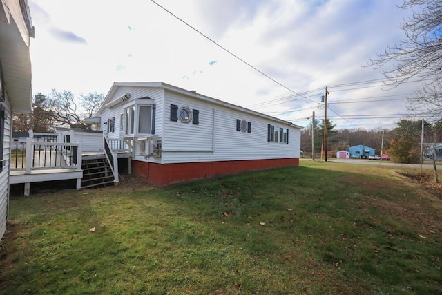 view of home's exterior with a yard and a wooden deck