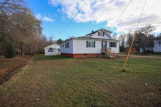 bungalow with entry steps and a front lawn