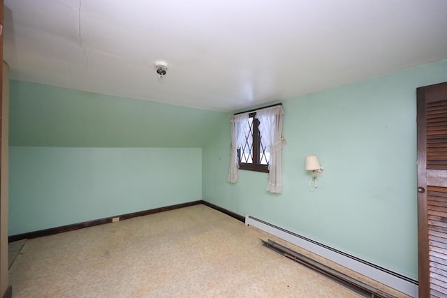 bonus room featuring a baseboard radiator, vaulted ceiling, and baseboards