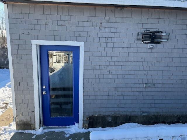 view of snow covered property entrance