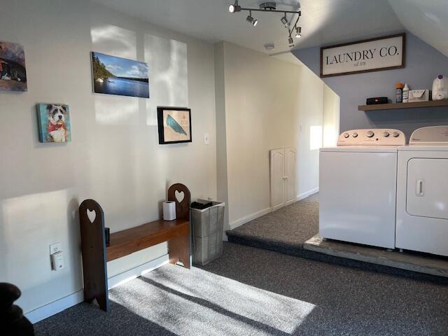 laundry room featuring carpet flooring and separate washer and dryer