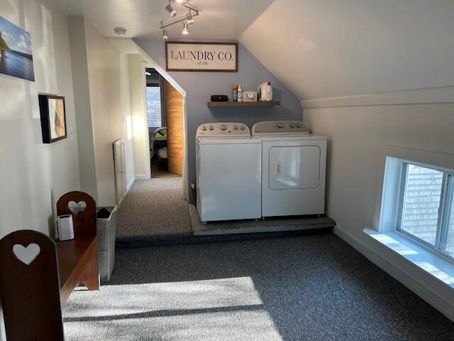 washroom featuring washing machine and clothes dryer and carpet flooring