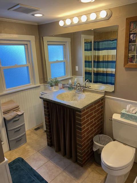 bathroom featuring tile patterned floors, vanity, toilet, and a shower with shower curtain