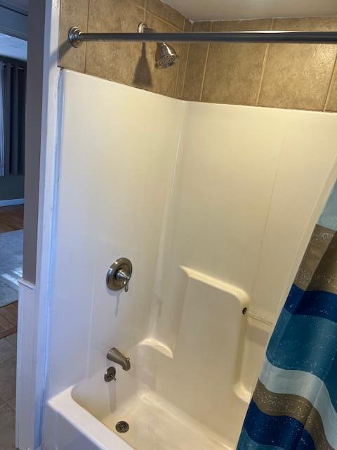 bathroom with shower / tub combo with curtain