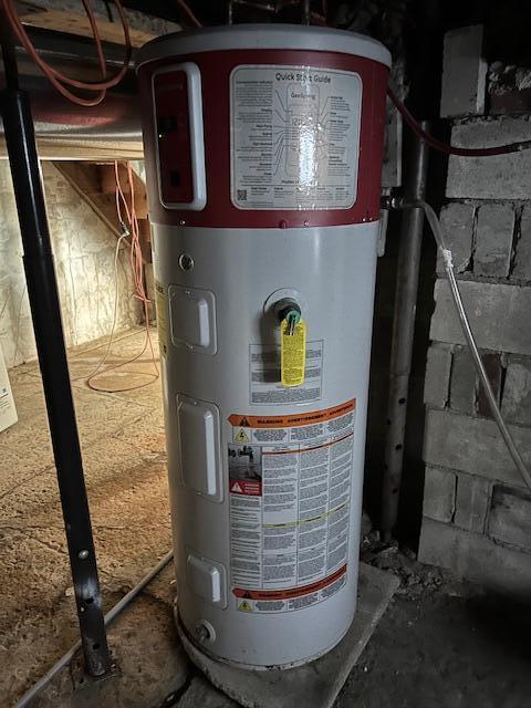 utility room featuring water heater