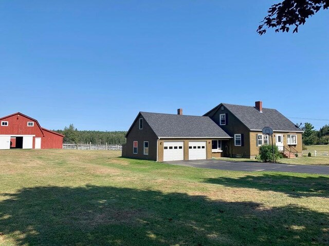 view of front of property with an outbuilding, a garage, and a front yard