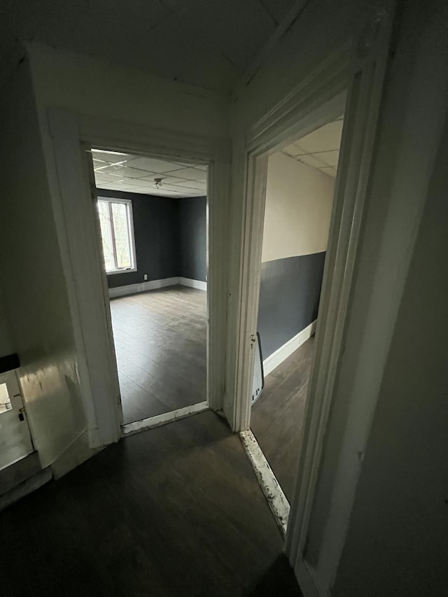 hall featuring wood finished floors and baseboards