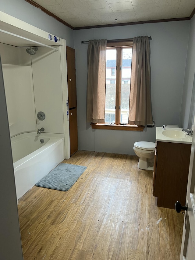 bathroom with ornamental molding, vanity, toilet, and wood finished floors