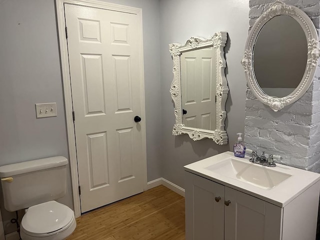 bathroom featuring hardwood / wood-style flooring, vanity, and toilet