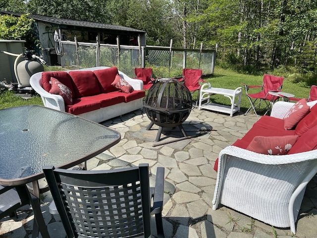 view of patio featuring an outdoor living space with a fire pit