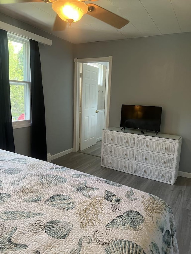 bedroom with ceiling fan and dark hardwood / wood-style flooring