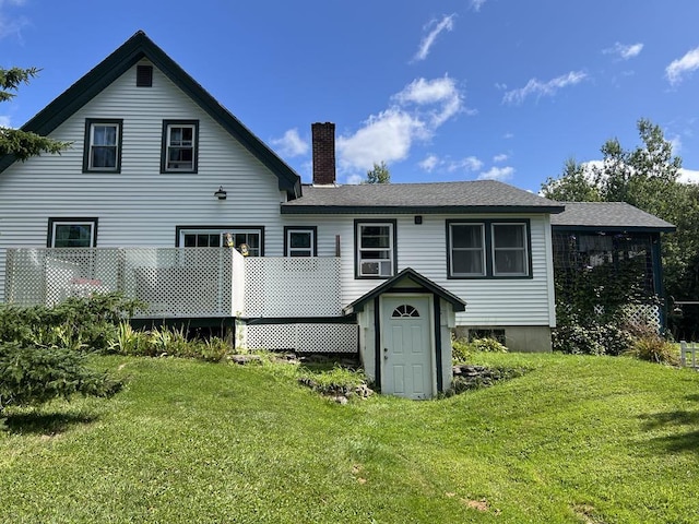 rear view of property featuring a yard