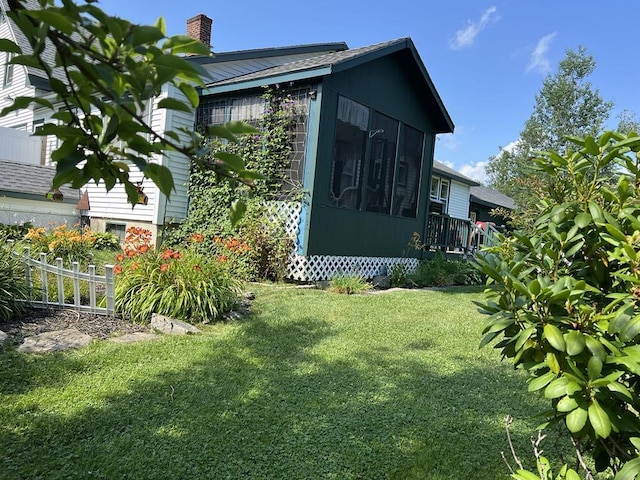 view of side of home with a yard