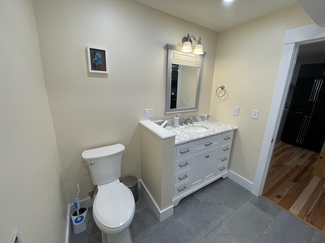 bathroom featuring toilet and vanity