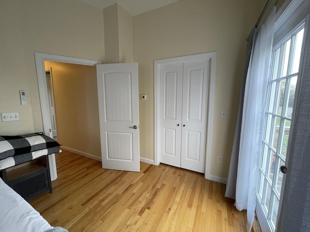 unfurnished bedroom with light hardwood / wood-style flooring and a closet