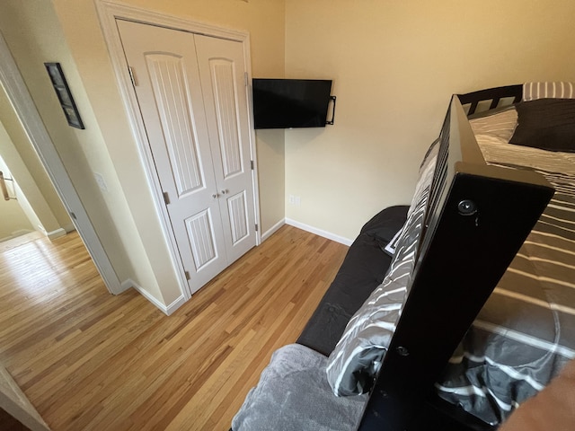 bedroom with hardwood / wood-style flooring and a closet