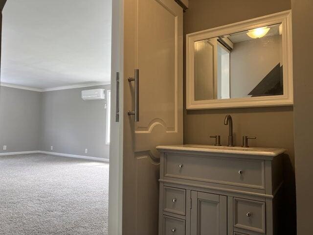 bathroom featuring vanity, crown molding, and a wall mounted air conditioner