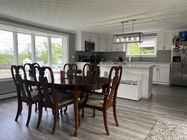 dining room featuring sink and hardwood / wood-style flooring