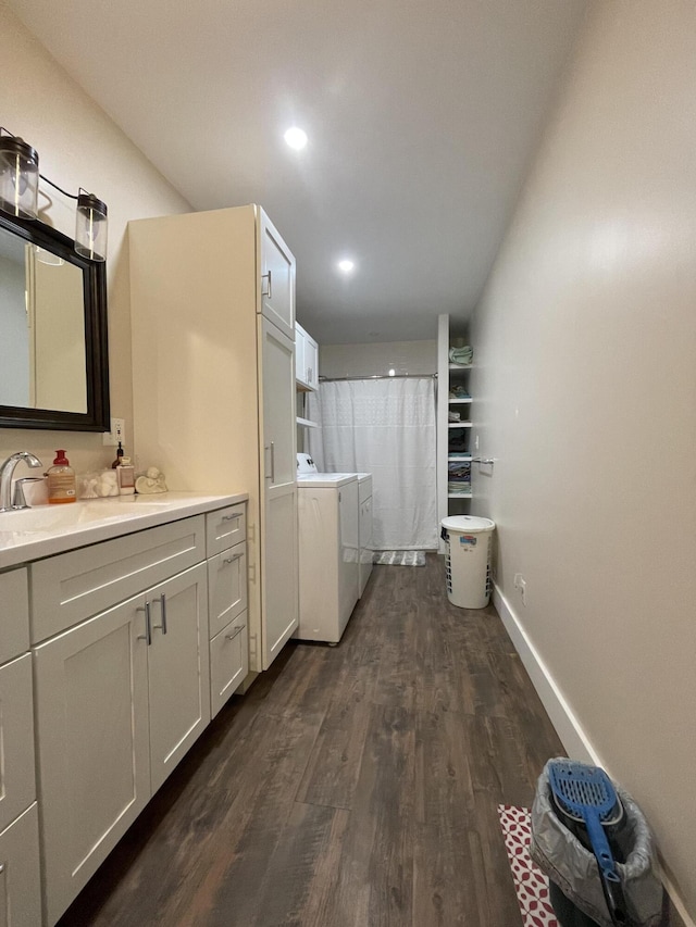 bathroom with sink, hardwood / wood-style floors, and independent washer and dryer