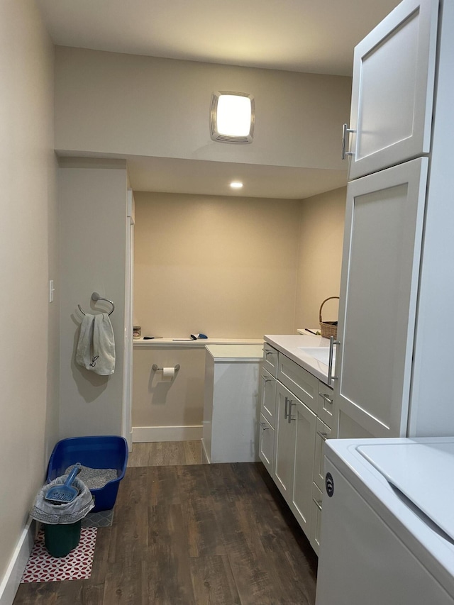 washroom featuring cabinets and dark hardwood / wood-style flooring
