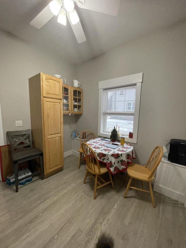 dining space featuring light wood-type flooring and ceiling fan