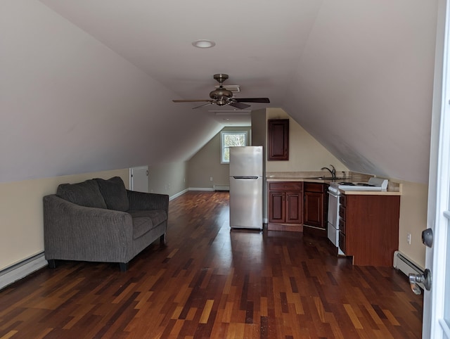 additional living space with sink, a baseboard heating unit, dark hardwood / wood-style floors, and lofted ceiling