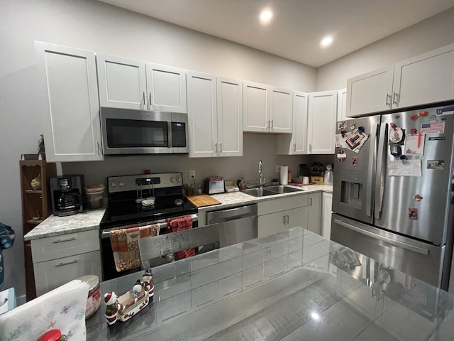 kitchen featuring sink, stainless steel appliances, and white cabinetry
