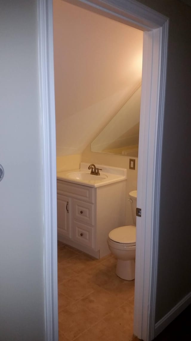 bathroom featuring vanity, toilet, and tile patterned flooring