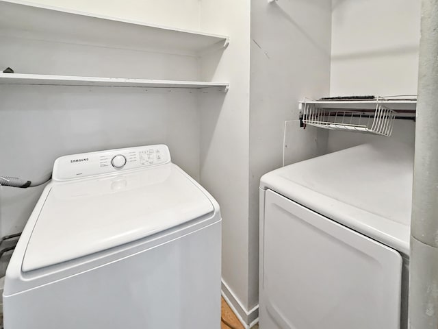 clothes washing area featuring independent washer and dryer