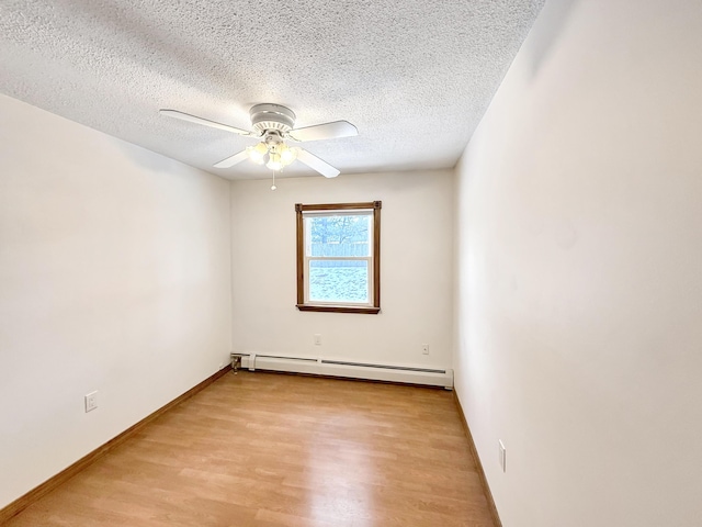 empty room featuring baseboard heating, light hardwood / wood-style floors, a textured ceiling, and ceiling fan