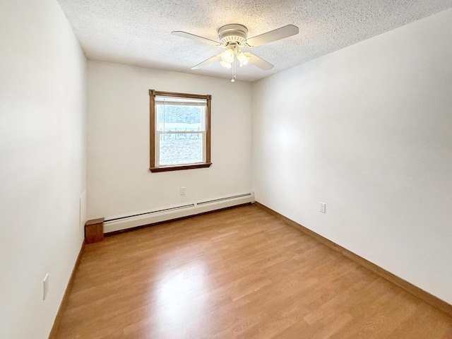 spare room featuring light hardwood / wood-style floors, a textured ceiling, a baseboard heating unit, and ceiling fan