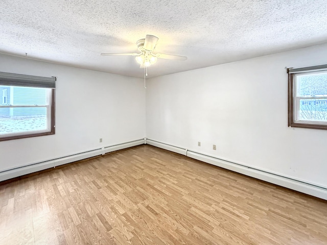 empty room featuring ceiling fan, a textured ceiling, and light wood-type flooring