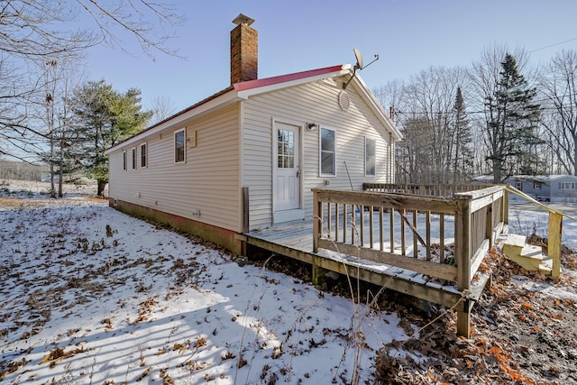 view of snowy exterior with a deck