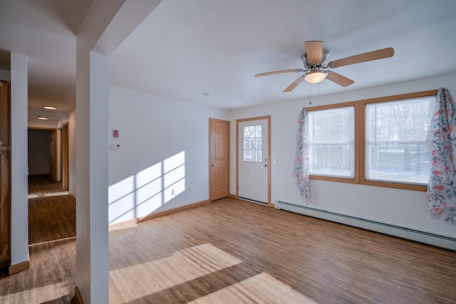 entrance foyer with hardwood / wood-style flooring, baseboard heating, and ceiling fan