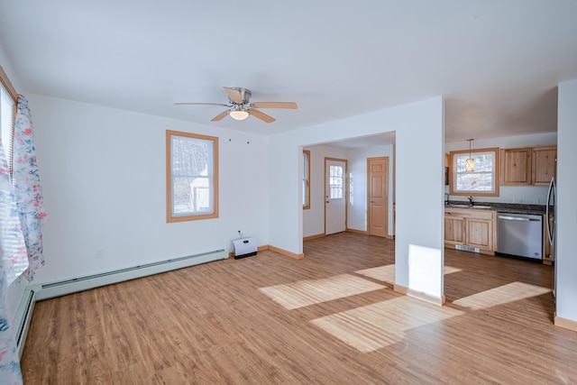 unfurnished living room featuring ceiling fan, light hardwood / wood-style flooring, and a baseboard radiator