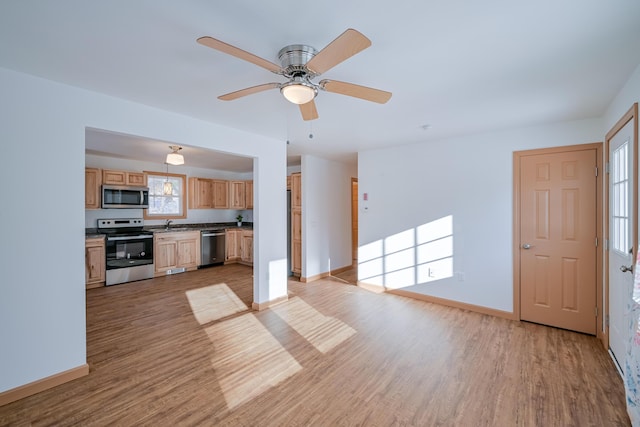 kitchen with light hardwood / wood-style floors, light brown cabinetry, stainless steel appliances, and ceiling fan