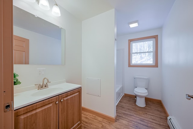 full bathroom featuring a baseboard radiator, shower / bathing tub combination, vanity, toilet, and hardwood / wood-style flooring