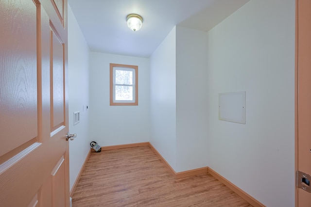 washroom with light hardwood / wood-style flooring and electric dryer hookup