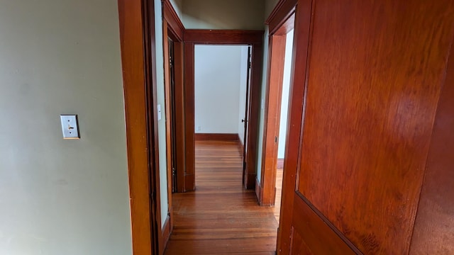 hall with hardwood / wood-style flooring