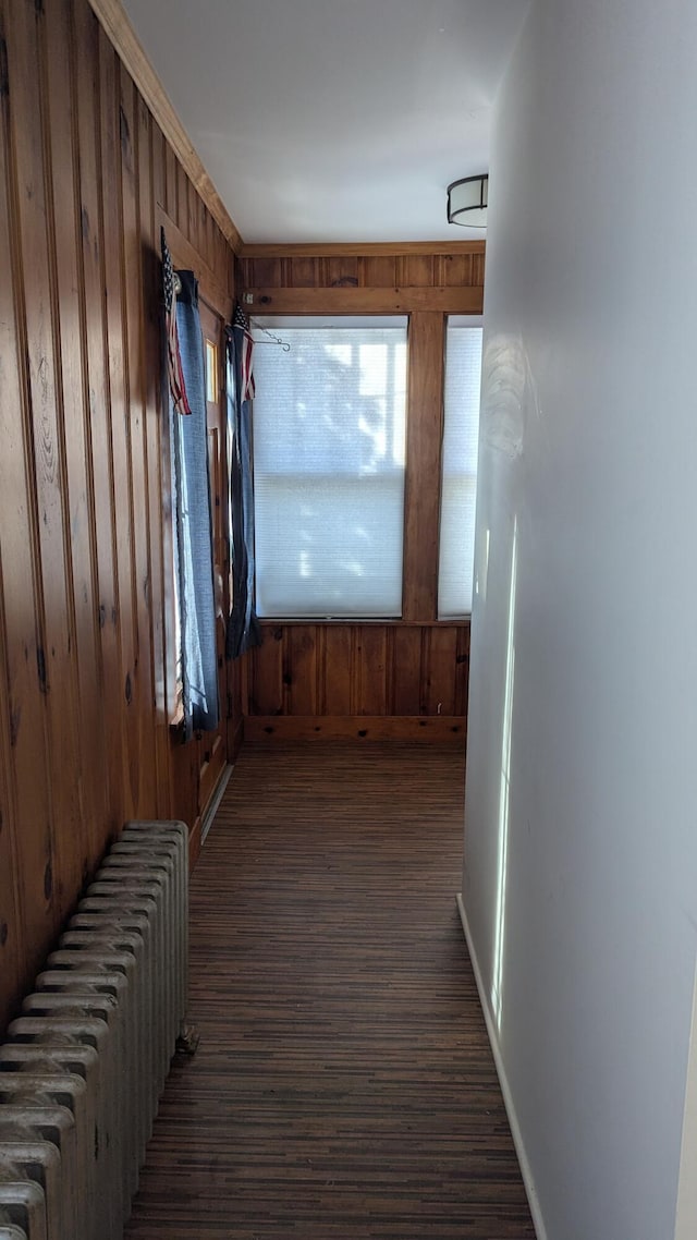 corridor with radiator heating unit and wood walls