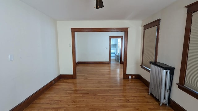 hall featuring radiator and light hardwood / wood-style floors