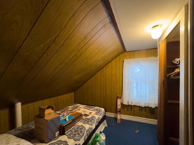 bedroom with vaulted ceiling, wood walls, and carpet flooring