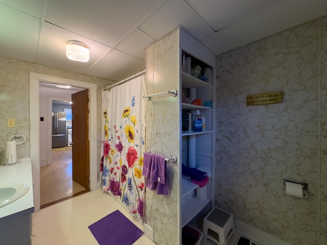 bathroom with a shower with shower curtain and vanity