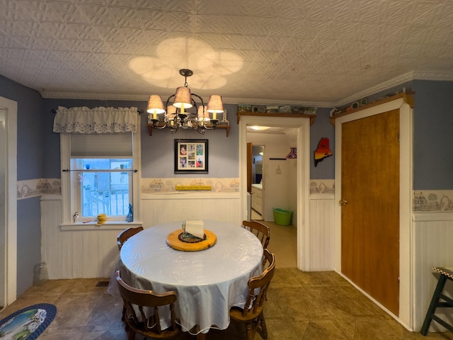 dining area with a notable chandelier and crown molding