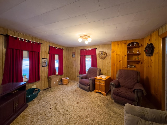 living room featuring wood walls and carpet flooring