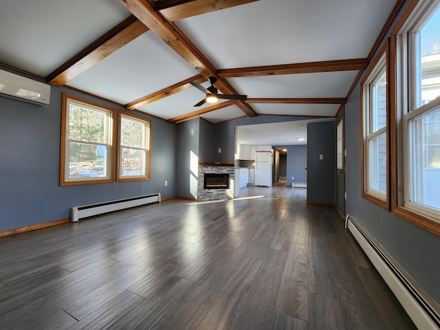 unfurnished living room featuring a baseboard heating unit, a wealth of natural light, and vaulted ceiling with beams