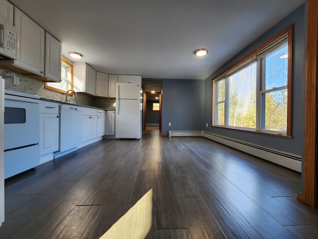 kitchen featuring backsplash, white appliances, white cabinets, and plenty of natural light