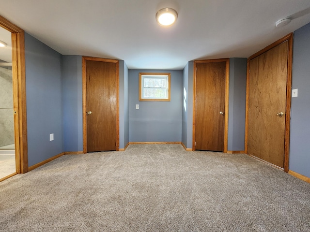 unfurnished bedroom with light carpet and ensuite bathroom